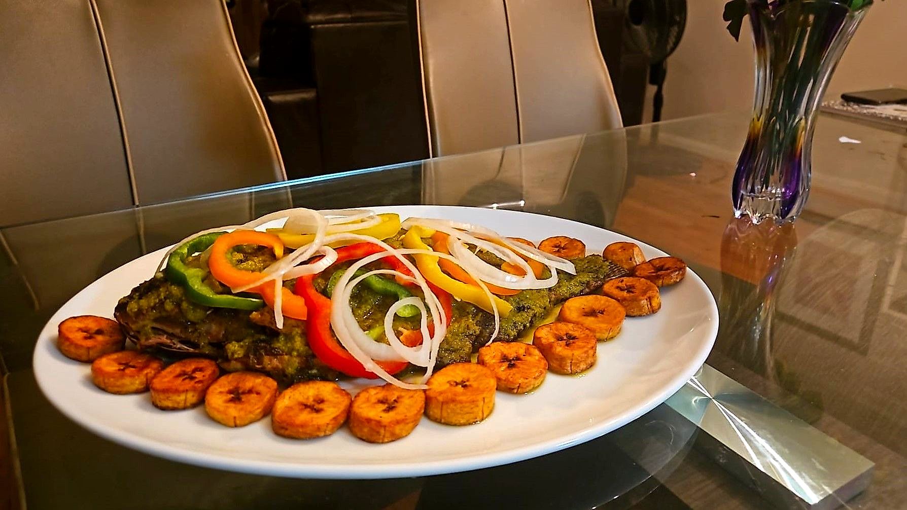 Baked tilapia fish with plantain and hot sauce $35.00